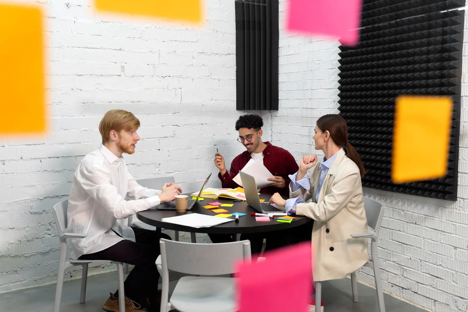 Property management team reviewing plans around a conference table